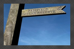 Wooden sign pointing towards Fairfield Nature Reserve in Lancaster