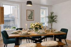Elegant open-plan kitchen diner at The Joseph Cosy with large sash windows and eight-seater dining table