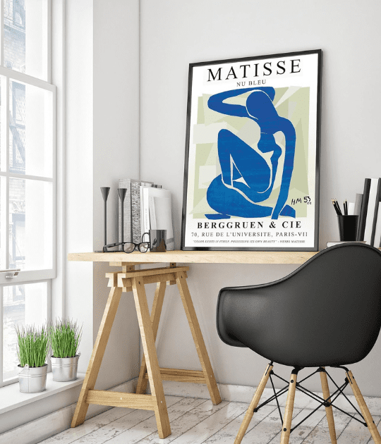 the print in a modern workspace, placed above a wooden desk with a sleek black chair, blending well with contemporary decor.