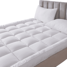 A thick, quilted white mattress topper sits atop a bed, adding an extra layer of softness and luxury, creating a hotel-like sleeping experience.
