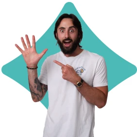 A bearded man in a white T-shirt raising his hand against a blue diamond-shaped background.