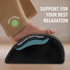 A black ergonomic footrest cushion with a curved design, being pressed by a foot.