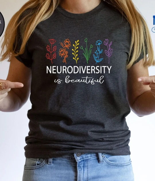 A close-up of the black version of the neurodiversity t-shirt, worn by a model pointing at the statement, emphasizing its bold and supportive message.