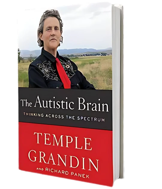 A photograph of Temple Grandin holding a copy of 