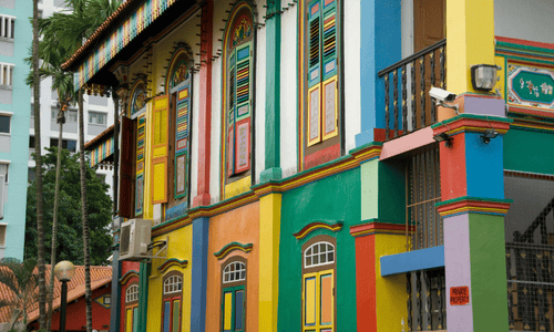 Traditional building with brightly painted walls, doors, and window frames in bold colors like yellow, red, blue, and green.
